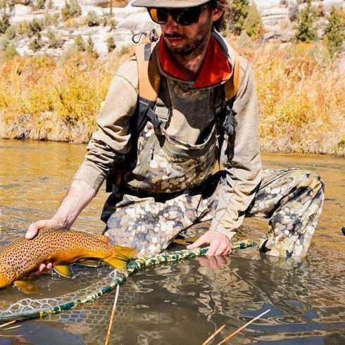 andrew with a sweet brown trout guided fly fishing in dolores